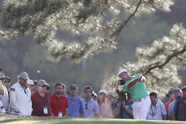 American Bryson DeChambeau hitting from the pine straw on the 17th hole in the first round of the Masters Tournament at Augusta, Georgia on Thursday. He had six birdies in his back nine and eight overall. 