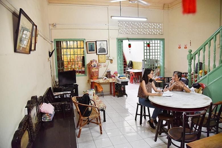 Fengzhu Gu (left) praying at the Guanyin Gong vegetarian hall in Cuff Road. Dr Show Ying Ruo (at left in centre picture), who studied these halls, says the shophouse that is home to the hall (right) was bought for $30,000.