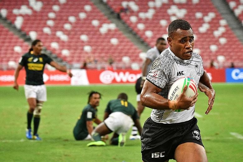 Fiji's Livai Ikanikoda evading his South African opponents to score a try in their Pool A match yesterday at the National Stadium. While they lost 17-7, Fiji were spared the blushes as surprise side Scotland had slumped to Canada 33-10 earlier.