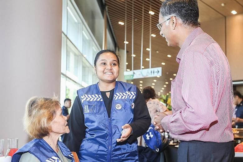 Left: Bukit Batok MP and GPC for Home Affairs and Law deputy chairman Murali Pillai with Citizens on Patrol (COP) volunteer Nur Arfa Muhammad Rahmat, 18, and her mother. Miss Arfa joined the scheme when she was 13. Right: Mr Ganesan Kulandai, 64, was