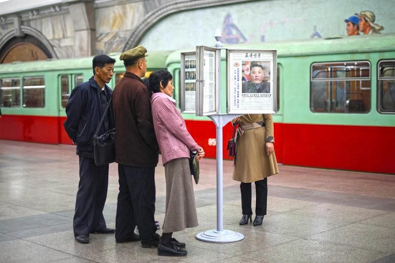 Commuters in Pyongyang yesterday reading a North Korean newspaper carrying an image of Mr Kim Jong Un. He said the US has been making unilateral demands and should abandon that approach.