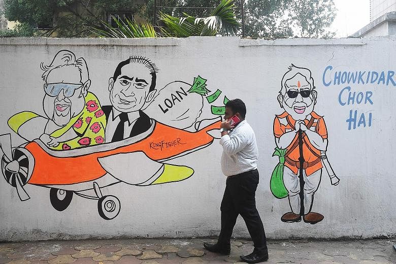 A mural in Kolkata depicting (from left) fugitive tycoons Vijay Mallya and Nirav Modi, and Prime Minister Narendra Modi.