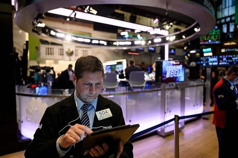A trader working ahead of the closing bell on the floor of the New York Stock Exchange last month. Even though the US earnings season has kicked into gear, traders will also be listening in on developments from the US and Japan trade talks today and 