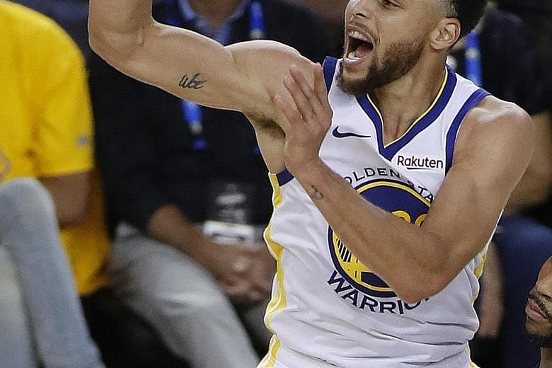 Warriors guard Stephen Curry, wearing contact lenses, showing just how he does it after making a three-pointer against the Clippers in Game 1 of their NBA Western Conference first-round series at the Oracle Arena in California. His eight treys mean h