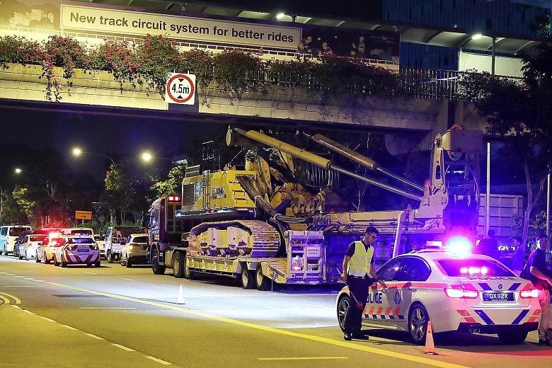 The scene of an accident where a crane collided with the underside of an overhead bridge across Jurong Town Hall Road on Saturday night. At 10.20pm, the Land Transport Authority tweeted that an accident had occurred in Jurong Town Hall Road towards S
