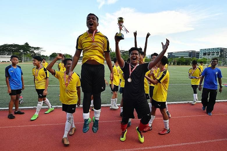 Guangyang Secondary School players celebrating after winning the Schools National B Division boys' football League Two final yesterday.