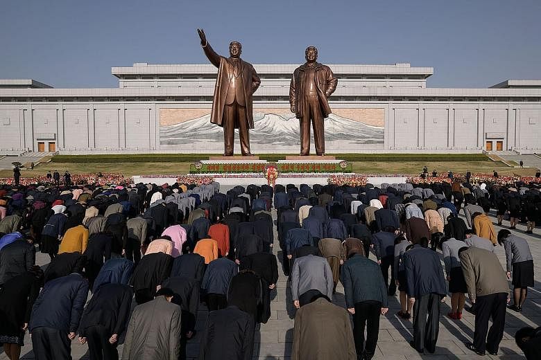 People bowing before the statues of North Korean founder Kim Il Sung and his son Kim Jong Il on Mansu hill in Pyongyang as part of Day of the Sun celebrations yesterday. Thousands turned out to pay their respects on Mr Kim Il Sung's birth anniversary