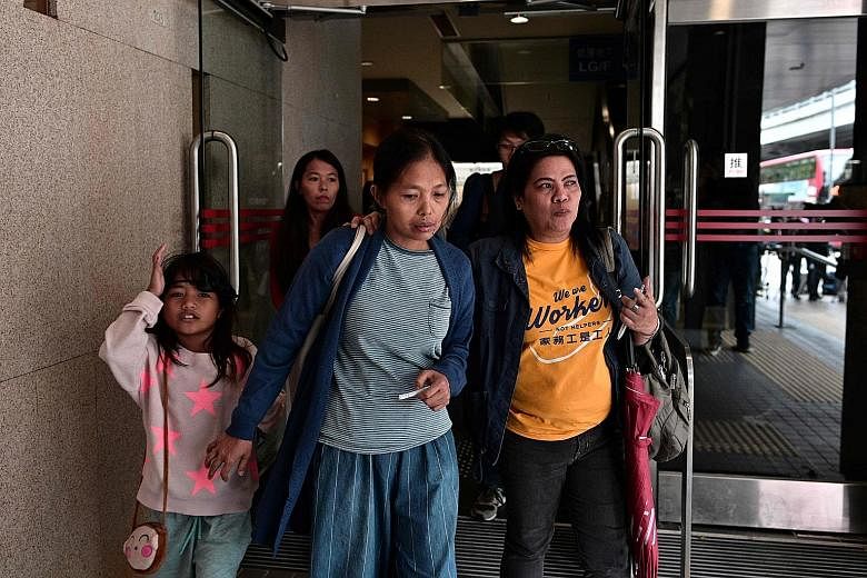 Philippine domestic worker Baby Jane Allas (centre), a single mother of five who was sacked by her employer after she was diagnosed with cancer, leaving with family members and supporters after a hearing at Hong Kong's labour tribunal yesterday. It o