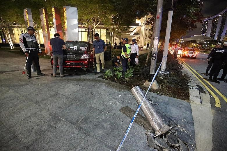 A car crashed into a metal bollard outside the Marina Bay Financial Centre yesterday evening. The 25-year-old driver has been arrested. PHOTO: LIANHE ZAOBAO