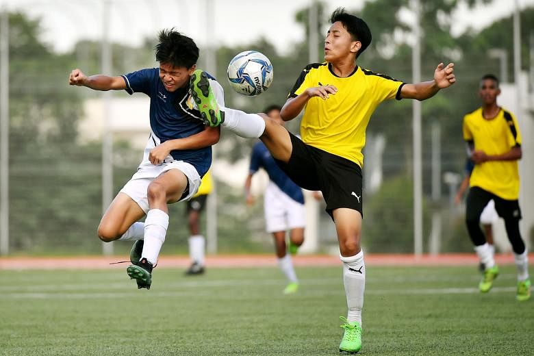 Above: Woodgrove Secondary player Shannel Saifudin (left) challenging Guangyang Secondary's Ashish Budha Magar for the ball. Left: Guangyang players celebrating with the trophy - their first B Division title.