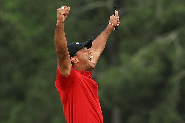 Tiger Woods shows his emotions after sinking his putt on the 18th green on Sunday at Augusta National Golf Club to win his fifth Masters title.