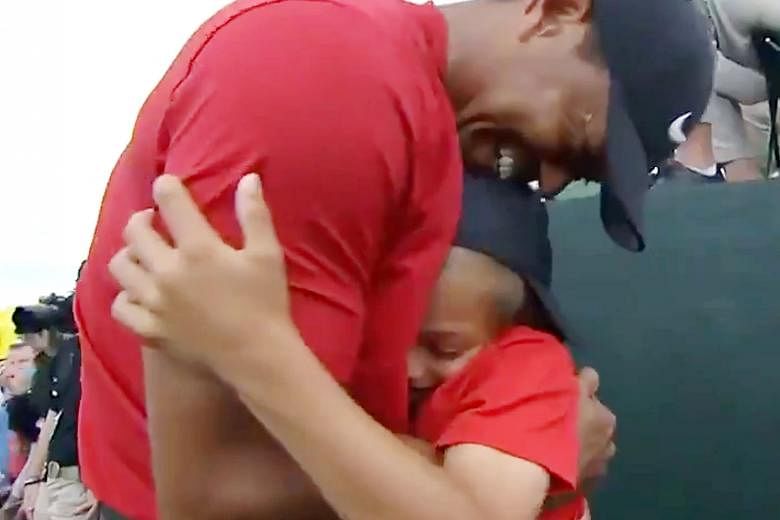 Left: Last year's champion Patrick Reed helping Tiger Woods put on the Green Jacket. Above: Soon after Woods won, he hugged his son Charlie at almost the exact spot he hugged his late father Earl (right) back in 1997 when Woods won his first Masters 