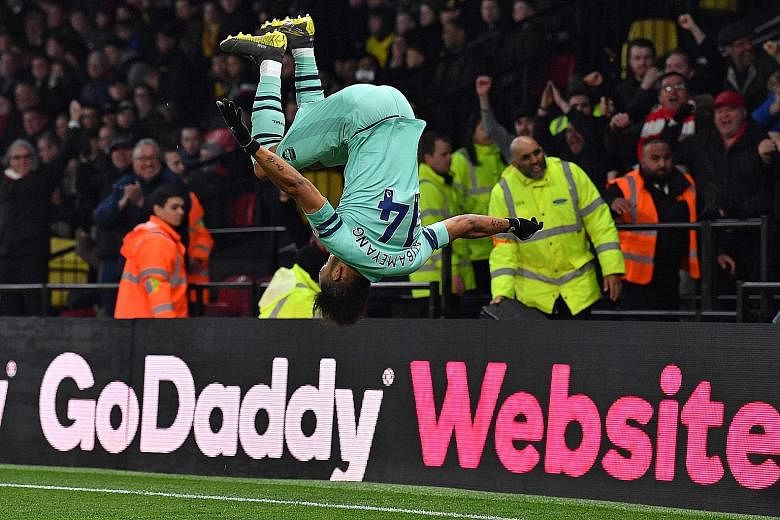 Arsenal's Gabonese striker Pierre-Emerick Aubameyang enjoying his trademark somersault after scoring in the English Premier League against Watford at Vicarage Road Stadium. It was the game's only goal. PHOTO: AGENCE FRANCE-PRESSE