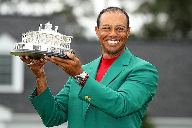 Tiger Woods with the Masters trophy on Sunday, his fifth win at Augusta National, and 15th Major victory overall. PHOTO: REUTERS