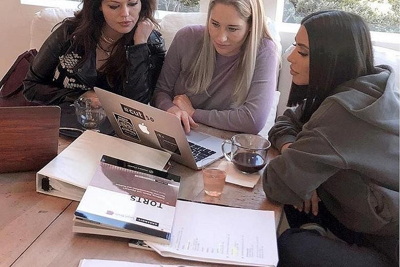 KARDASHIAN KEEPING UP: Kim Kardashian (left) wants law and order in her life, now that she wants to become a lawyer. 	"My weekends are spent away from my kids while I read and study," she posted on Monday. 	On other days, she added: "I work all day, 