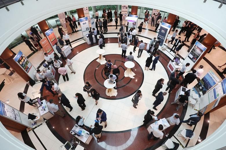 Booths showcasing clean energy projects by various firms at the EcoLabs Centre of Innovation for Energy, which was launched yesterday. The centre, housed at Nanyang Technological University, will work with corporate partners and investors to provide 