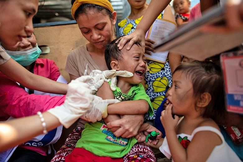 A child in Manila, Philippines, being vaccinated against measles in February. Several countries, including the Philippines, were hit by fresh measles outbreaks, the World Health Organisation said on Monday. So far this year, 170 countries have report