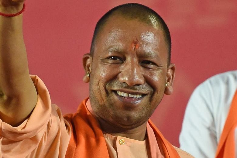 Uttar Pradesh Chief Minister Yogi Adityanath of the BJP is barred from campaigning for 72 hours for making religiously polarising speeches. An electrician testing LED-fitted boards with symbols of India's ruling Bharatiya Janata Party and the main op