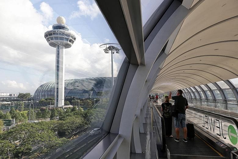 Visitors enjoying the 40m-high HSBC Rain Vortex, the world's tallest indoor waterfall, which cascades from an oculus in the roof and streams down seven floors to Basement 2. The water falls at a velocity of 10,000 gallons per minute. Located where an