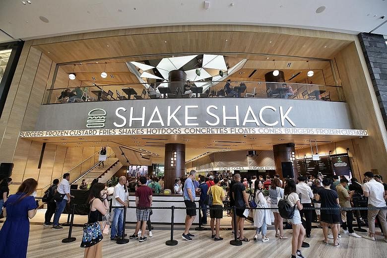 Diners queueing up for Shake Shack at Jewel Changi Airport, which opened its doors to the public yesterday. The Jewel outlet is the New York burger chain's first in Singapore. ST PHOTO: KEVIN LIM