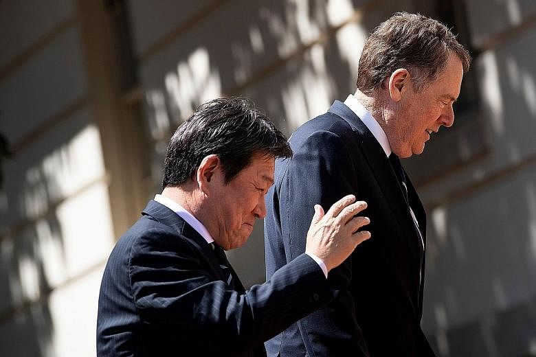 Japanese Economy Minister Toshimitsu Motegi and US Trade Representative Robert Lighthizer in Washington on Tuesday. Mr Motegi says he will be back in the US next week for another meeting with Mr Lighthizer. PHOTO: AGENCE FRANCE-PRESSE