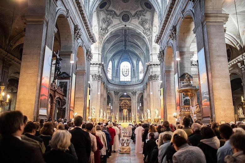 Catholics worshipping in Saint-Sulpice Church. It is one of two churches where Catholics in Paris will commemorate holy week, after a fire heavily damaged Notre-Dame Cathedral on Monday. PHOTO: DPA