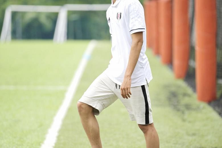 Fulham academy director Huw Jennings is impressed by the versatility of Singaporean footballer Ben Davis (left), who played mostly for the club's Under-18 team in the U-18 Premier League this season. ST PHOTO: LIM YAOHUI