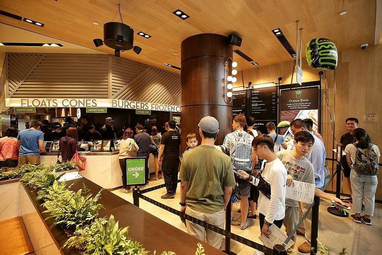 Customers queueing at Jewel Changi Airport's Shake Shack on Wednesday. Changi Airport is seeking to boost its position as an air hub of choice through Jewel to attract more stopover visitors and tourists as other airports in the region step up their 