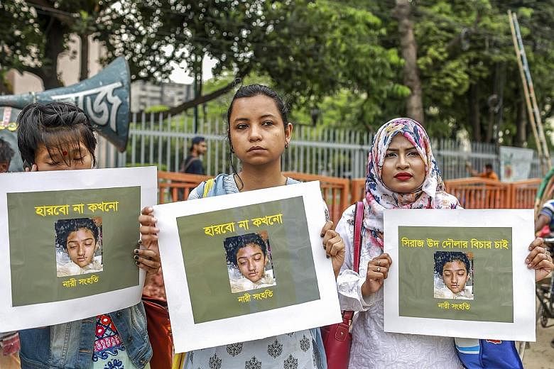 Protesters in Dhaka holding placards with Nusrat Jahan Rafi's photo after she died earlier this month. Police say her head teacher ordered her to be burned to death after she accused him of sexual harassment.