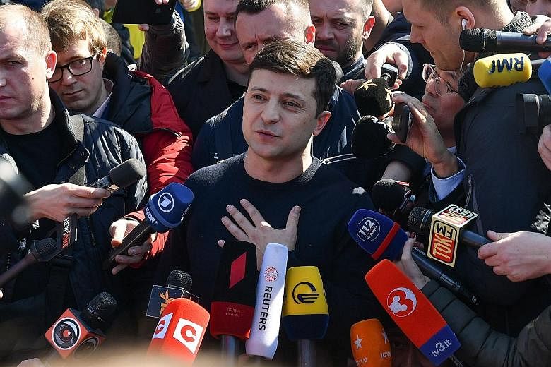 Mr Volodymyr Zelensky speaking to the media after voting at a Kiev polling station last month. He is expected to win the Ukrainian presidency in tomorrow's run-off polls.
