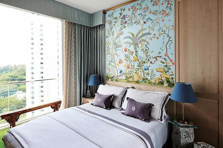 The bedroom features hand-painted silk wallpaper as well as porcelain garden stools that double as bedside tables.