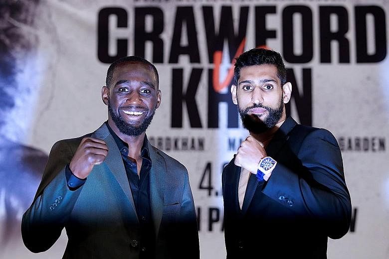 Terence Crawford and Amir Khan during their Wednesday press conference at New York's Madison Square Garden, where tonight's fight will take place. The 31-year-old American is putting his 34-fight unbeaten record on the line against the Briton, who is the 