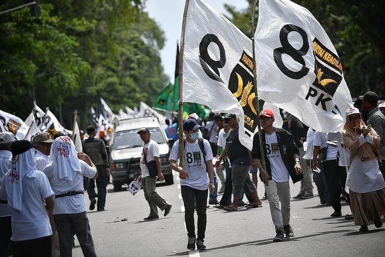 Supporters of the Islamic-leaning Prosperous Justice Party at Indonesian presidential candidate Prabowo Subianto's rally in Solo in Central Java last week. The party garnered 8.6 per cent of votes in the legislative elections, according to unofficial