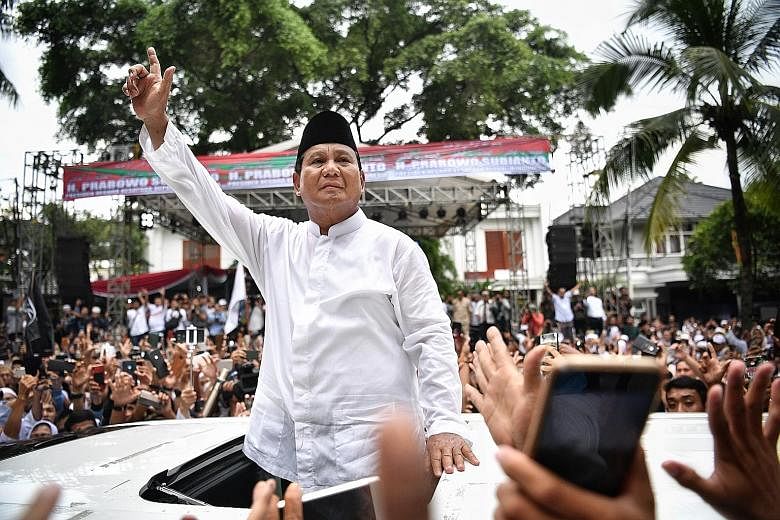Indonesian presidential hopeful Prabowo Subianto meeting his supporters outside his home in South Jakarta yesterday. The gathering was organised by Mr Prabowo's supporters to mark the end of Wednesday's peaceful general election and for him to repeat