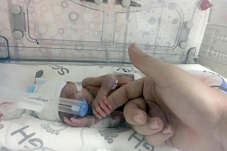 Ms Chloe Wilkinson, 30, went into labour at just 24 weeks during a layover in Singapore with her partner, Mr Patraic Walsh-Kavanagh, 27. Just a few weeks ago, the couple held their son for the first time. The newborn, who weighed just 870g when he wa