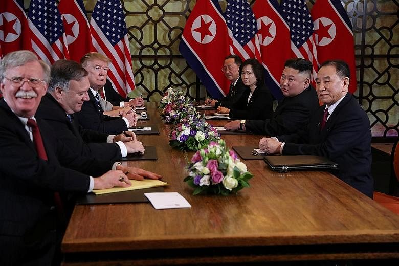 US President Donald Trump and North Korean leader Kim Jong Un with (from left) National Security Adviser John Bolton, US State Secretary Mike Pompeo and North Korean Foreign Minister Ri Yong Ho in Hanoi on Feb 28.