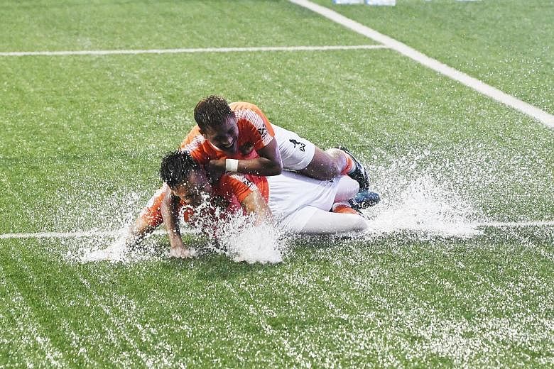 Top: Afiq Yunos (left) scoring the third goal for Hougang in their 4-1 Singapore Premier League win over Geylang yesterday. Soaked with joy, he then proceeded to celebrate with teammate Afiq Noor. ST PHOTOS: KHALID BABA