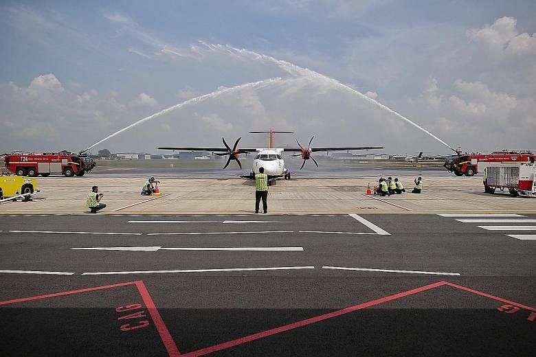 Malaysian carrier Firefly's aircraft receiving a water cannon salute at Seletar Airport after completing its inaugural flight from Subang Airport yesterday. The new GPS-based instrument approach procedures to enhance flight safety at Seletar Airport 