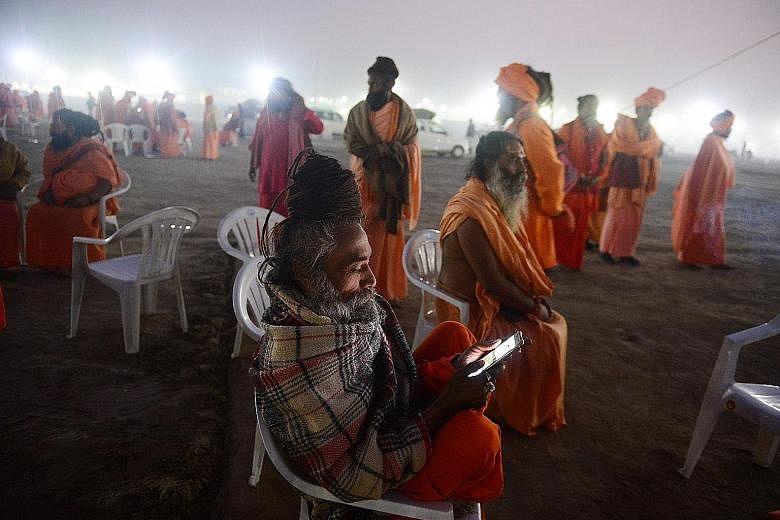 An Indian sadhu (holy man) engrossed in his smartphone ahead of a festival in north India. To hundreds of millions of young and poor Indians, the smartphone offers their first simultaneous experience of a camera, computer, television, music player, v