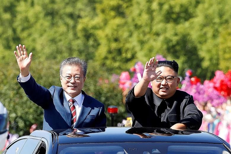South Korean President Moon Jae-in (left) and North Korean leader Kim Jong Un at a parade in Pyongyang last September. Seoul will celebrate the anniversary of last year's inter-Korean summit on Saturday at Panmunjom, where the summit was held, but wh