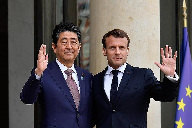 Japanese Prime Minister Shinzo Abe and French President Emmanuel Macron at the Elysee Palace in Paris yesterday.