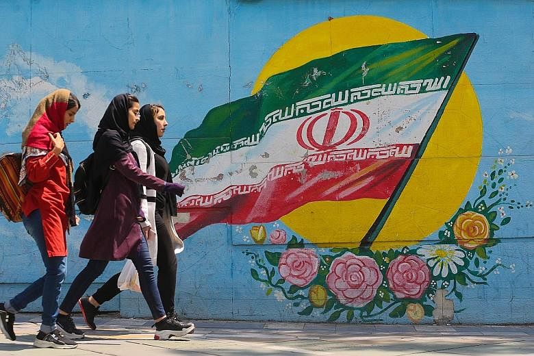 A mural showing the Iranian flag in Teheran yesterday. On Monday, the White House said it would end the six-month sanction waiver for all buyers of Iranian crude from May 1.