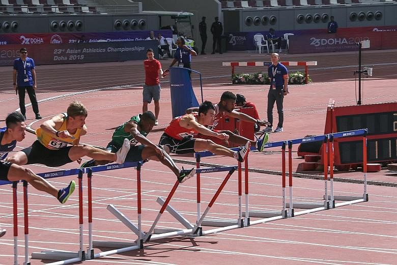 Ang Chen Xiang (second from right) hit the first hurdle hard during his 110m hurdles race at the Asian Athletics Championships in Doha yesterday but still set a national record of 14.25 seconds.