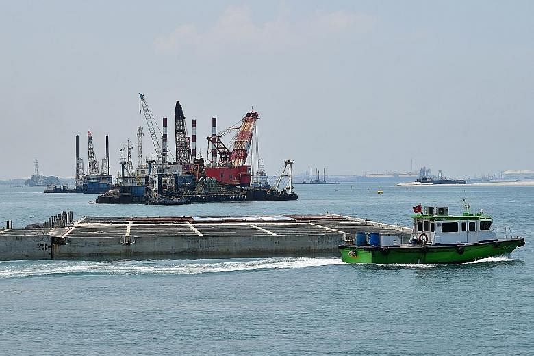 The final caisson (centre) at the first phase of the Tuas mega-port. The first phase will be fully operational in 2027 and cost $2.42 billion. The completed port is set to be the world's largest single-container terminal.
