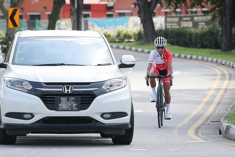 Chelsie Tan stresses that one should cycle as close to the kerb as possible, in case drivers make a left turn without signalling. ST PHOTO: ONG WEE JIN