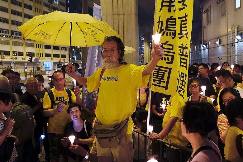 Pro-democracy supporters attending a candlelight vigil yesterday to support four jailed leaders of the 2014 pro-democracy "Occupy" movement. PHOTO: REUTERS