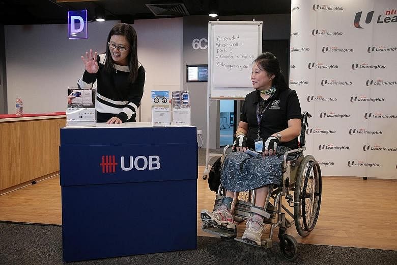 Deputy branch manager Heng Siew Pheng of UOB's Tampines branch and Disabled People's Association ambassador Margaret See at the Service Inclusiveness Programme's media launch event.
