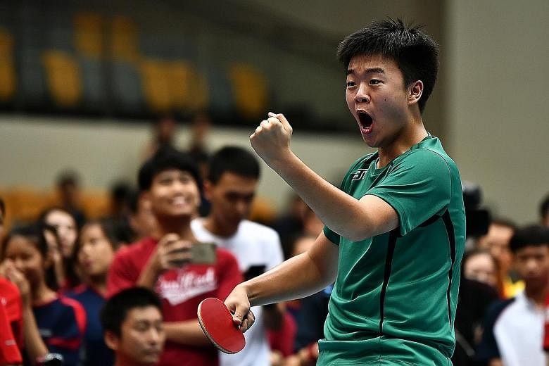 Raffles Institution's Lim Jun Kai reacting in joy after winning his team's deciding match against Jaedon Foo of Hwa Chong Institution in the B Division boys' final yesterday. ST PHOTO: LIM YAOHUI