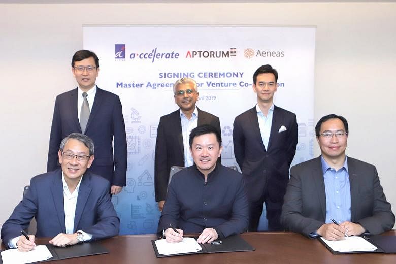 Representatives at the signing of the agreement to co-create local deep tech start-ups in the healthcare and life sciences sector: (seated from left) Mr Philip Lim, CEO of A*ccelerate Technologies, Mr Ian Huen, founder and CEO of Aptorum Group, and M
