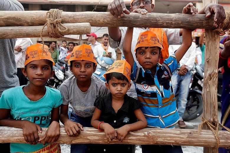 Children showing support for Indian Prime Minister Narendra Modi's Bharatiya Janata Party at a roadshow in Varanasi, India, yesterday.